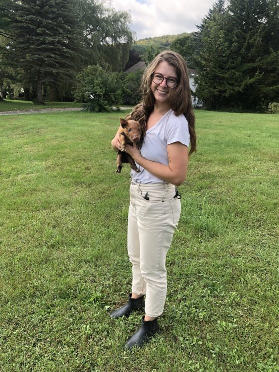 Photo of Anna Halpin-Healy holding piglet